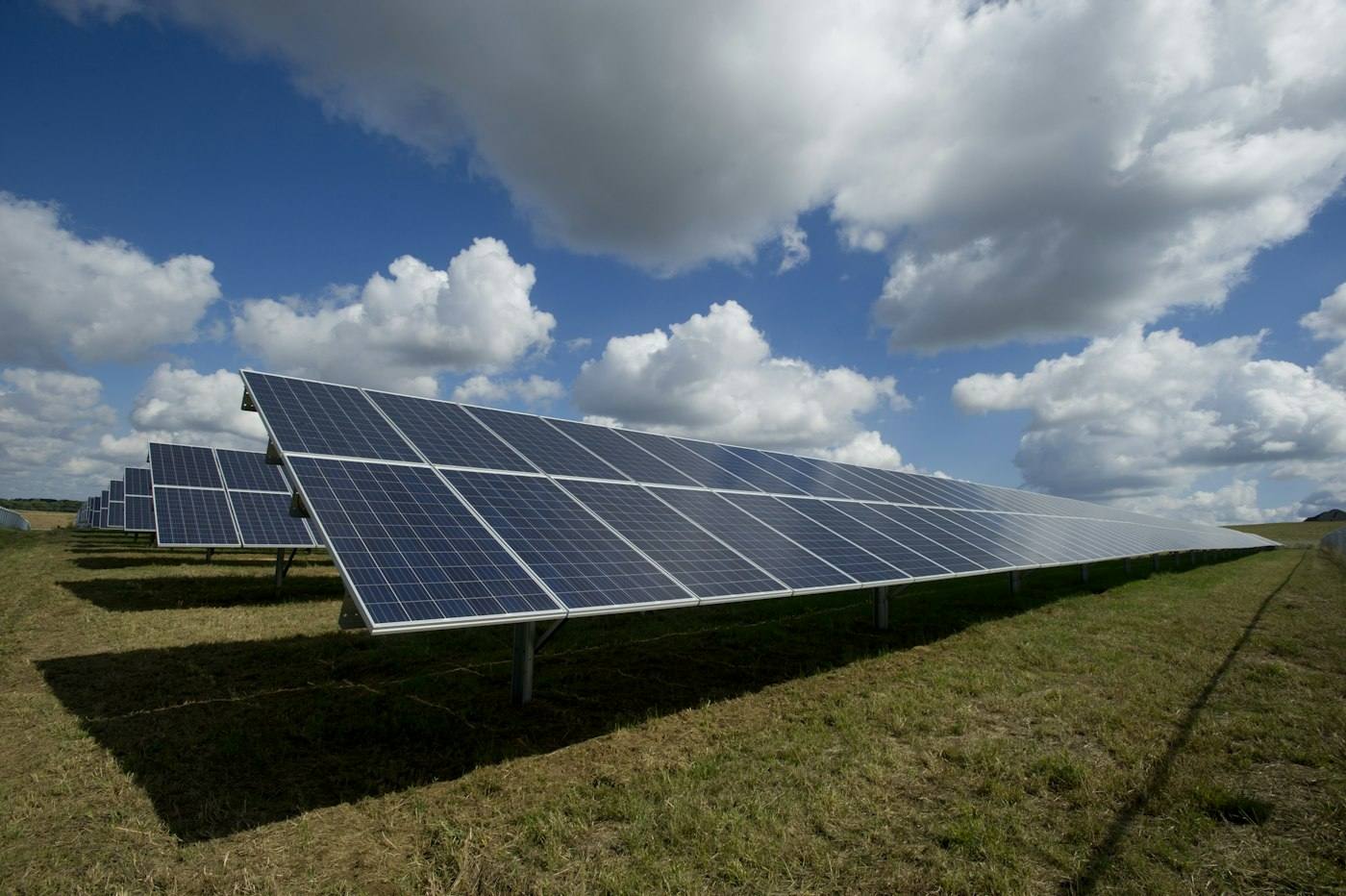 Grid-connected rooftop solar array under a blue sky